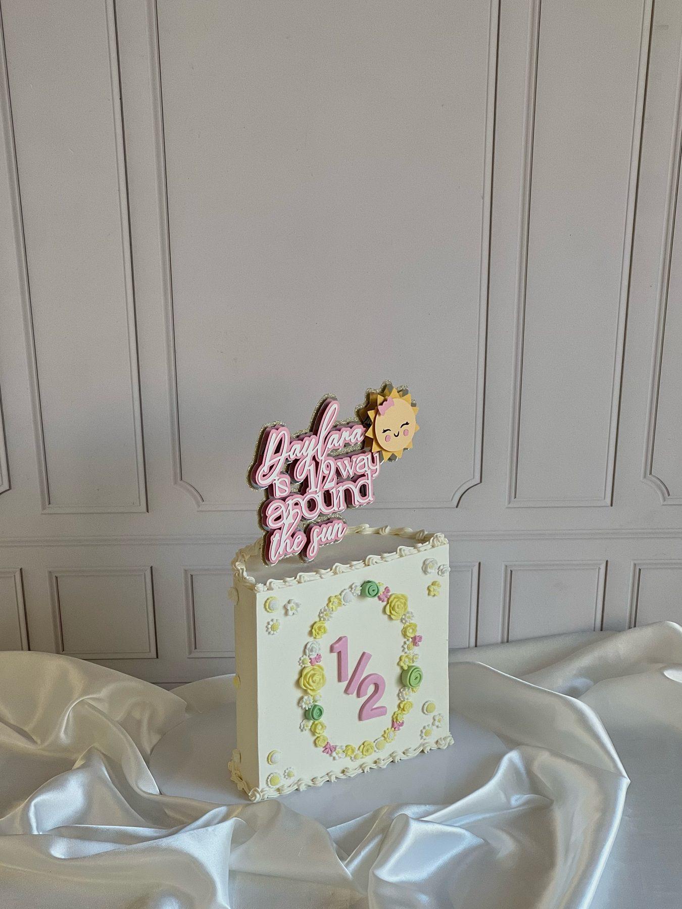 Half-birthday cake with pastel decoration