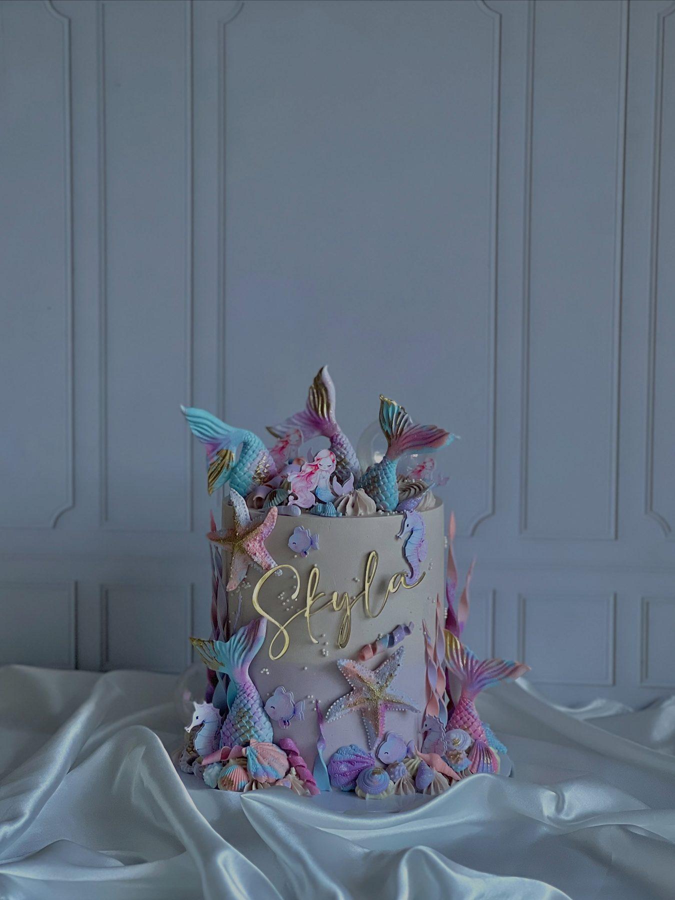 Mermaid-themed birthday cake with scale piping and shell details