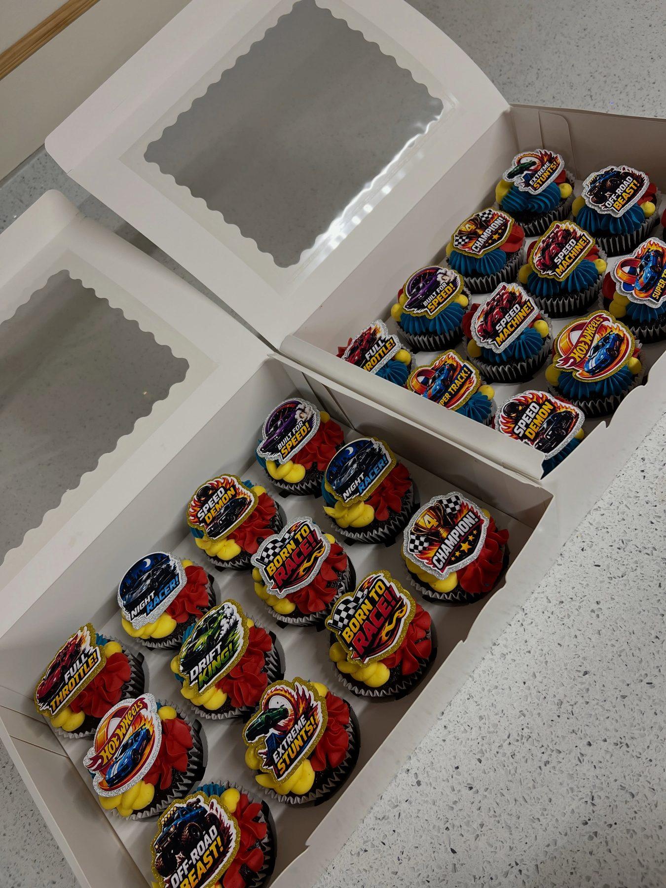 Hot Wheels-themed cupcakes with racing and monster-truck toppers