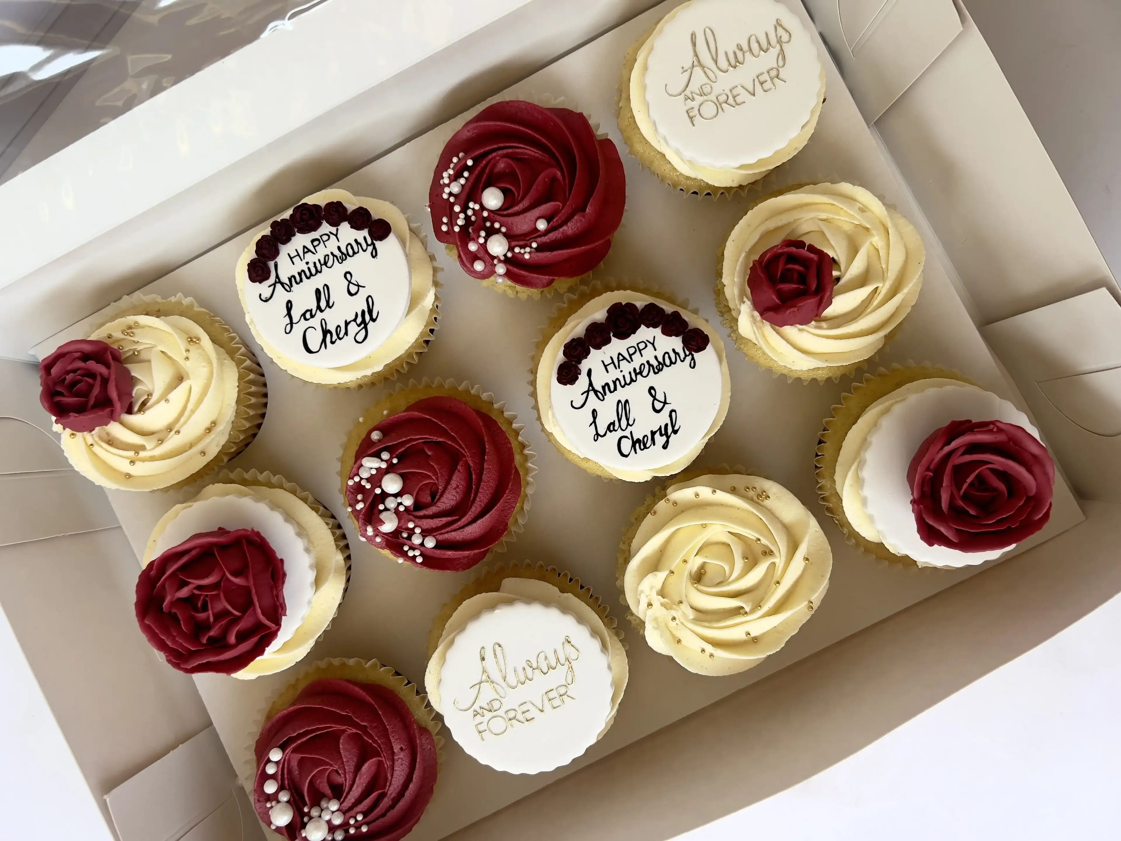 Cupcakes with burgundy and cream rosette piping and pearl detail, “Happy Anniversary” message plaques